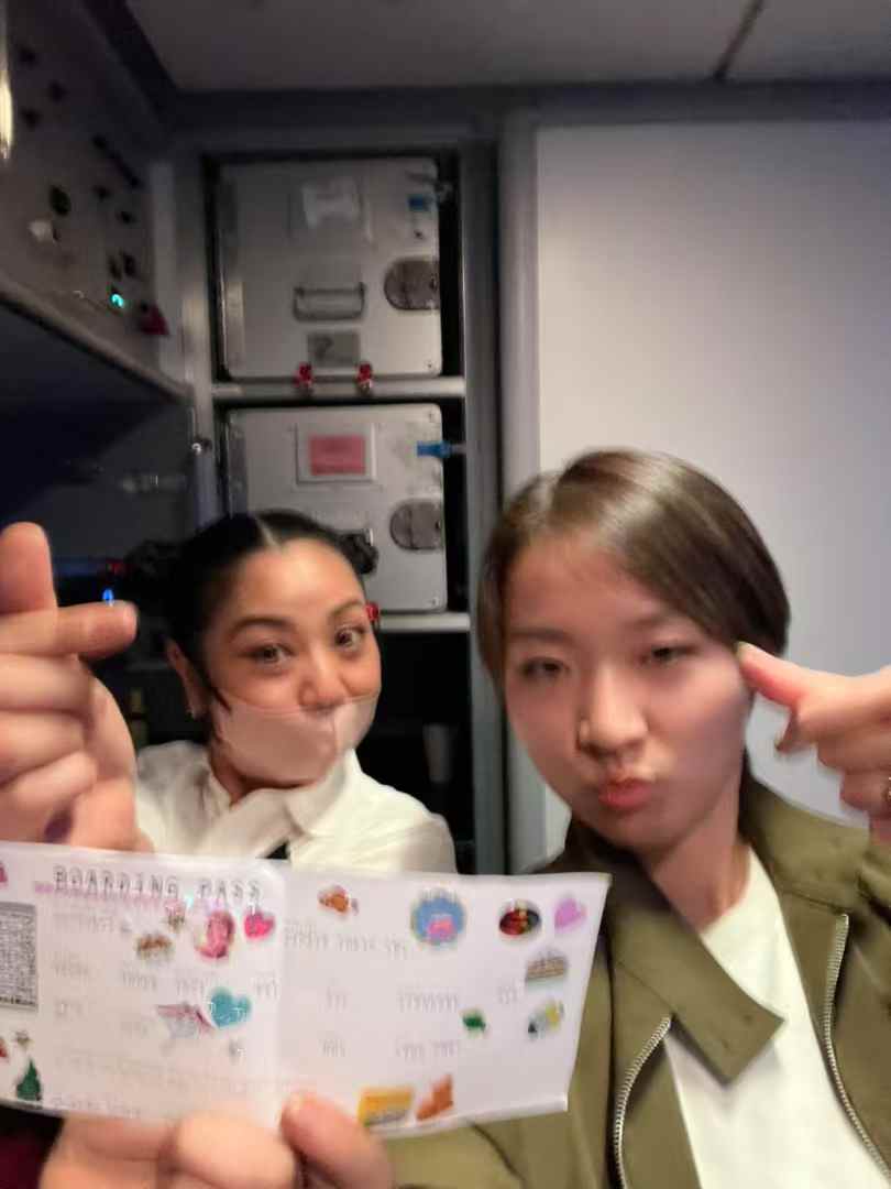 Fuma with a flight attendant in the aircraft galley