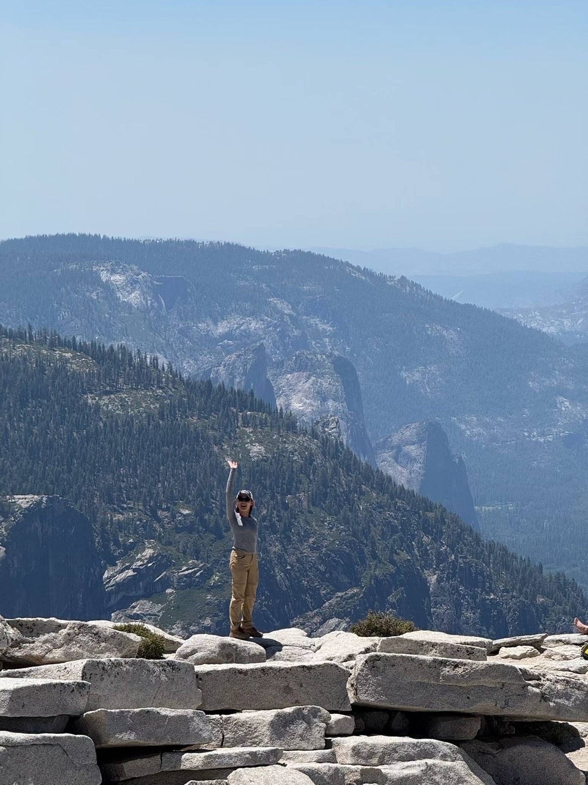 Fuma standing on Half Dome above Yosemite Valley