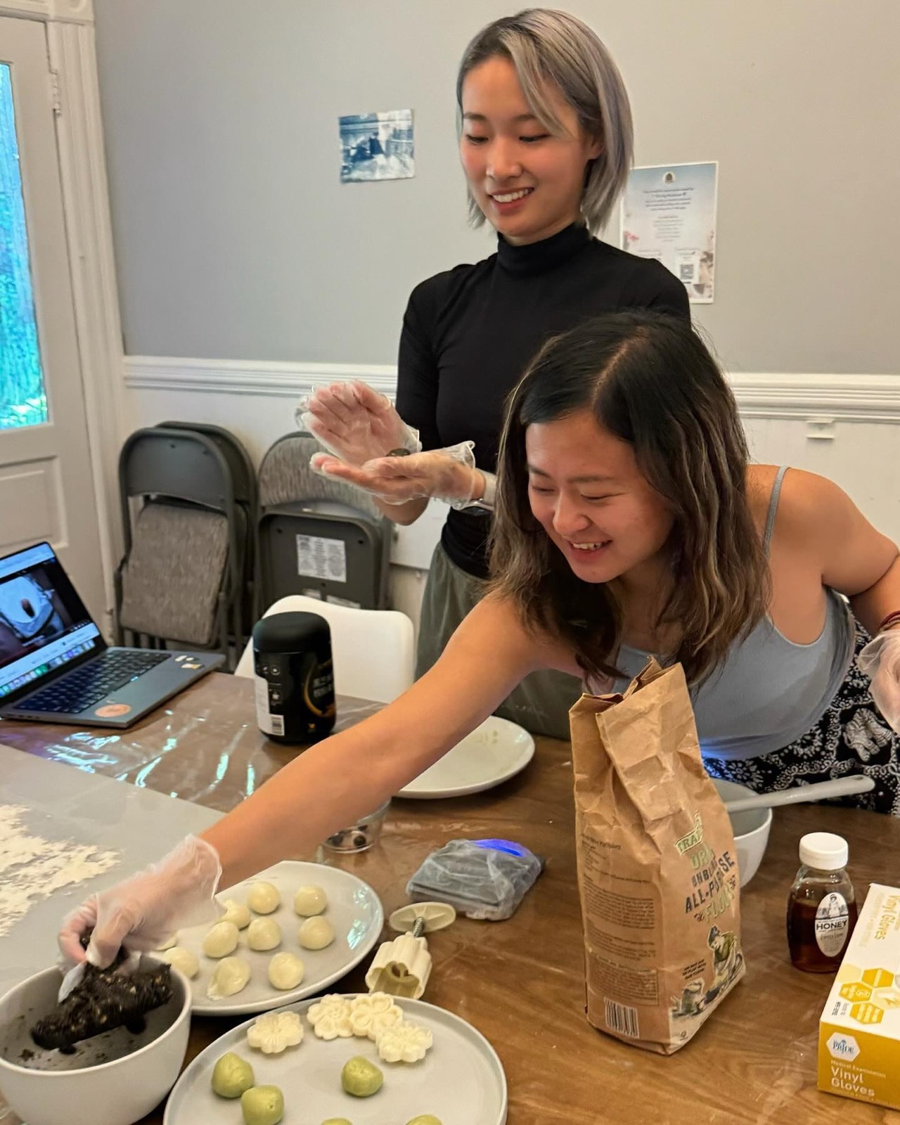 Friends making moon cakes together at a Thriving Mushrooms gathering