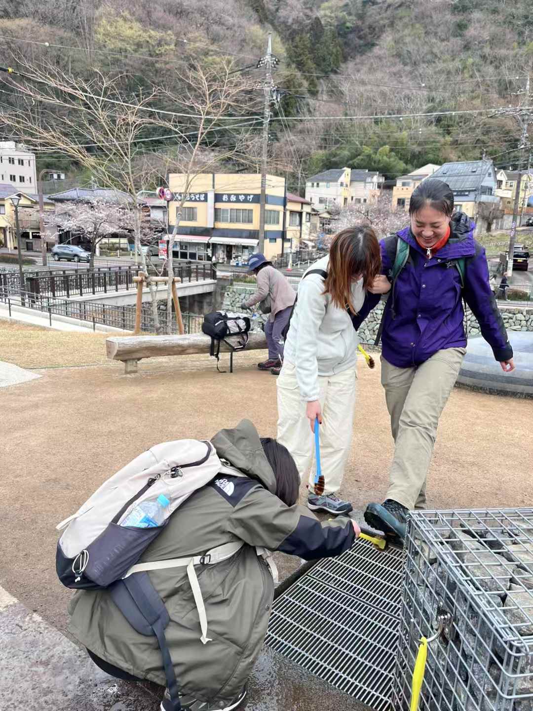 Friends standing beside the Mount Takao sign